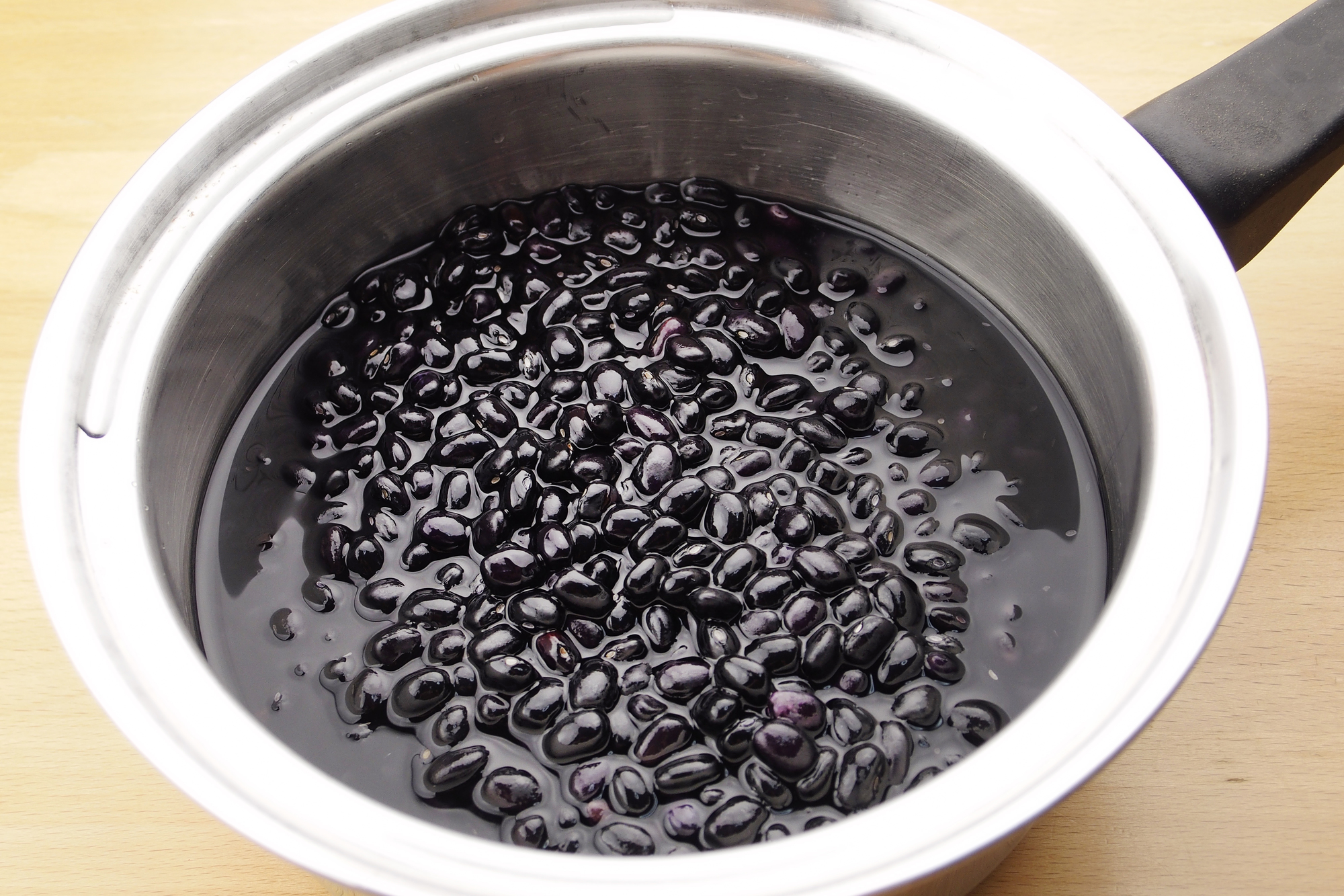 鍋で煮ている黒豆